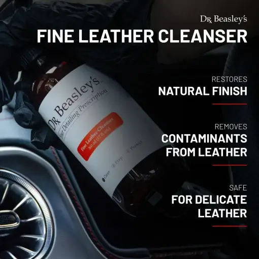 A 12 fl oz bottle of Fine Leather Cleanser placed on a car dashboard with product benefits displayed on a black background to the right.