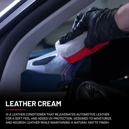 Leather Cream being applied to a leather dashboard using a white and red applicator.