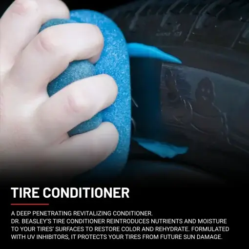 A hand applying blue Tire Conditioner using a blue foam applicator on a black tire.