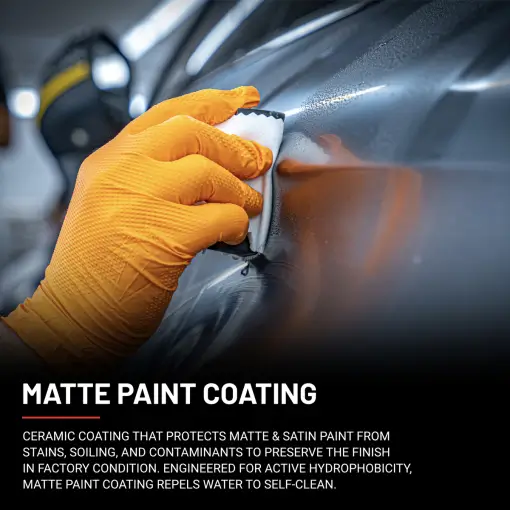 Hand in orange glove applies matte paint coating to matte grey Mercedes C63 AMG with yellow stripes.