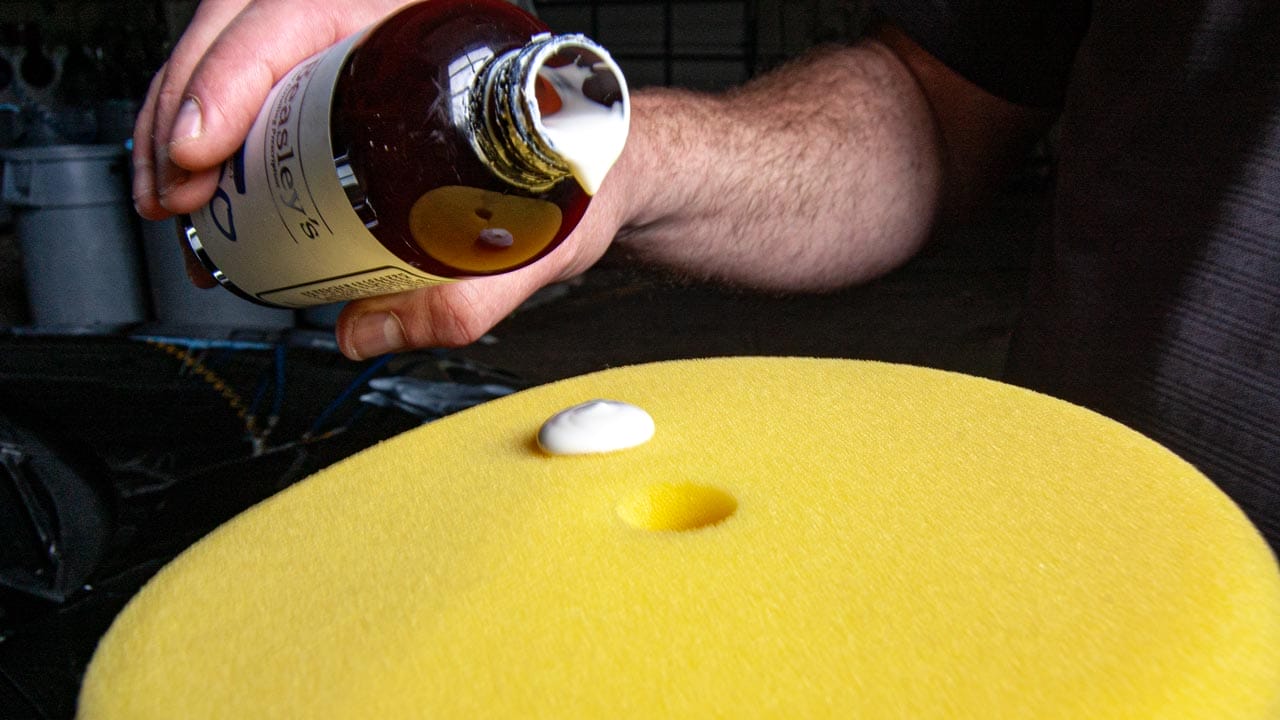 Applying cleaner wax to a polishing pad