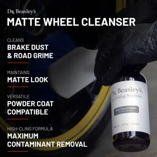 A person wearing a black glove holds a 12 fl oz bottle of Matte Wheel Cleanser in one hand and a Wheel Brush in the other.
