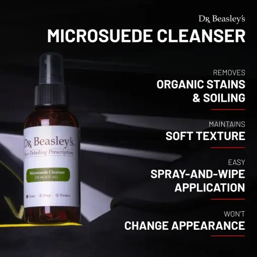 4 oz bottle of Microsuede Cleanser placed inside a black Alcantara interior.