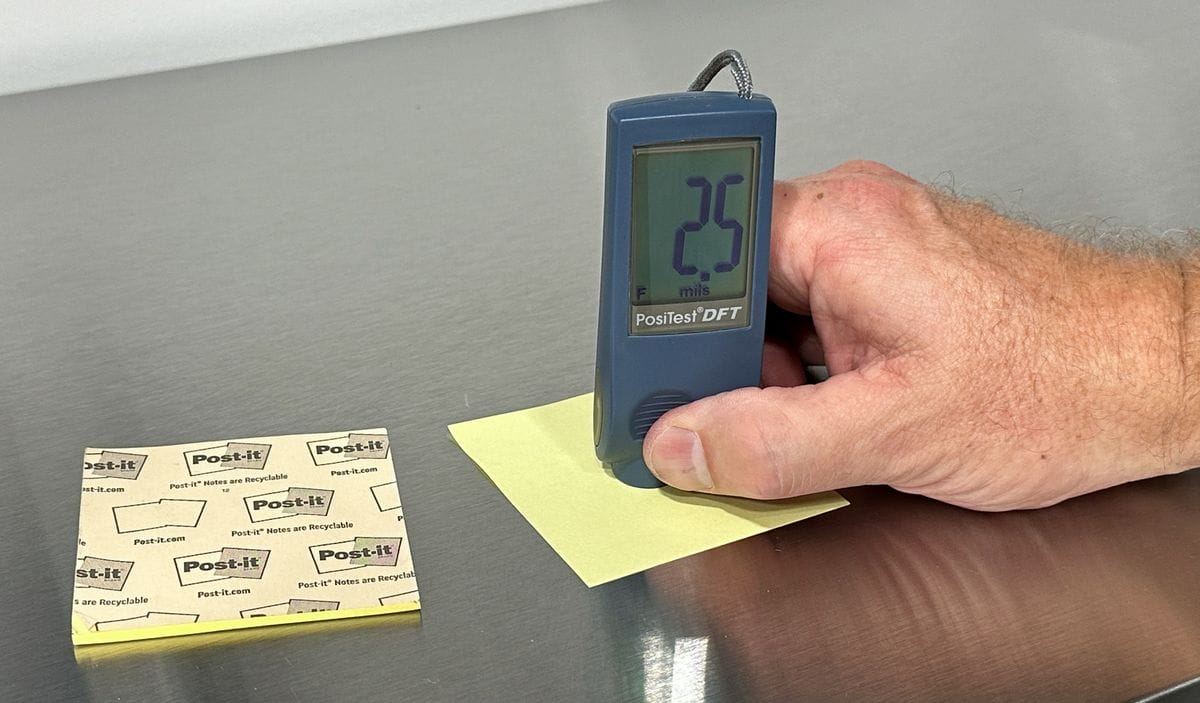 Demonstrating clear coat thickness by measuring thickness of a sticky note.