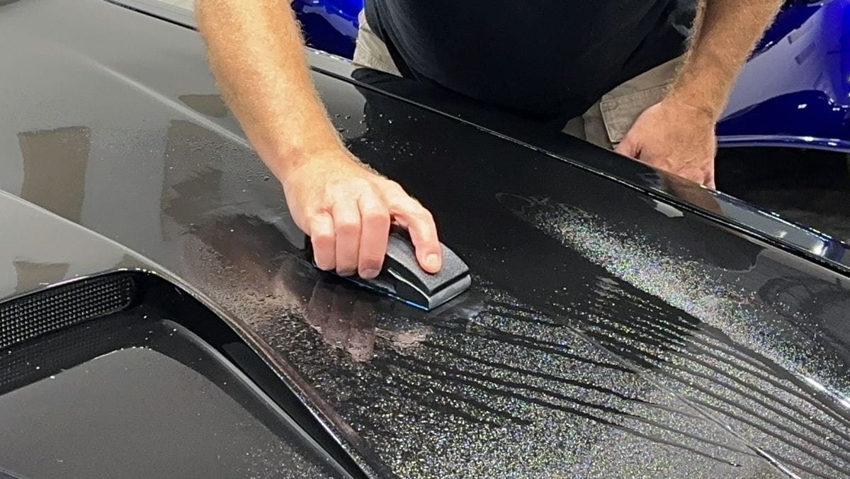 Wet sanding black paint.