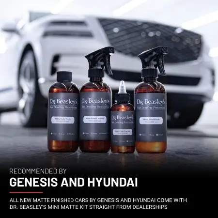 Four bottles of Matte Paint Prescription in front of a matte white Genesis GV80.