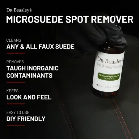 4 oz bottle of Microsuede Spot Remover placed inside a black Alcantara interior with red stitching.