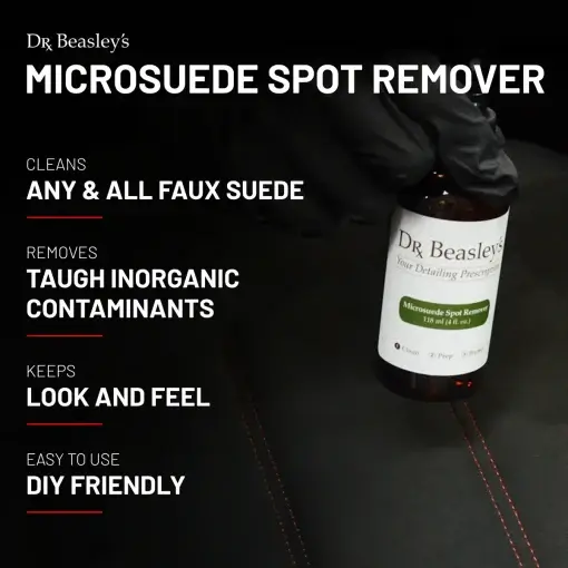 4 oz bottle of Microsuede Spot Remover placed inside a black Alcantara interior with red stitching.