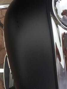 overspray on matte black paint on gas tank