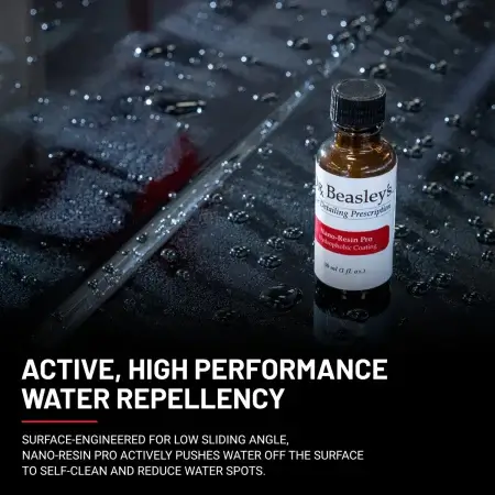 1 oz bottle of Nano-resin Pro placed on a black coated hood with water repellency effect.