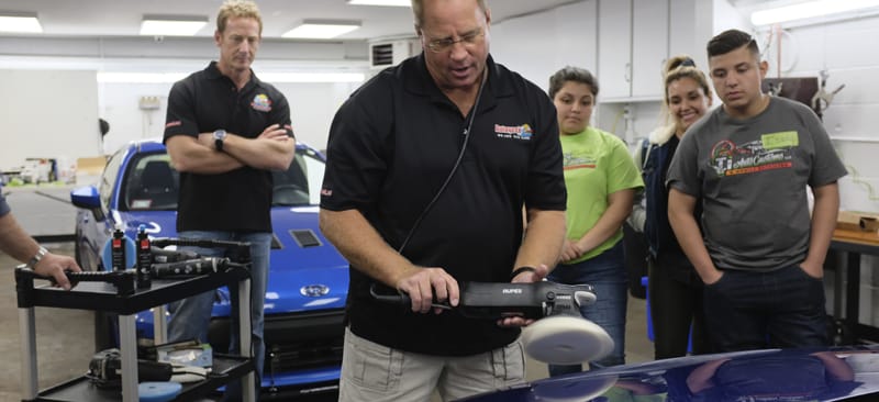 Mike Phillips shows Bruno Massel and the class how to polish a test spot