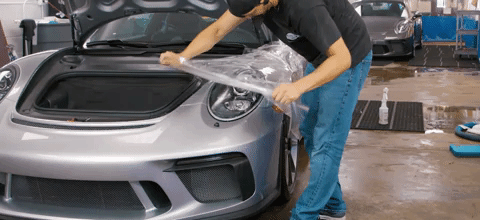 Paint protection film (PPF) being custom installed before applying a ceramic coating on PPF. 