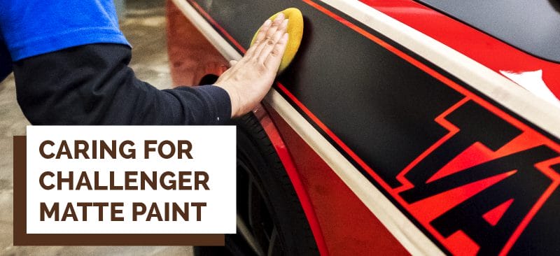 Detailer applying a ceramic coating to matte black challenger stripe