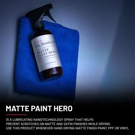 A 12 oz bottle of MAtte Paint Hero placed on blue towel on matte grey hood