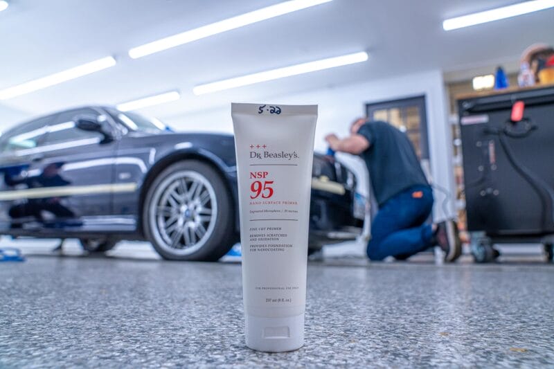 Tube of Dr. Beasley's NSP 95 in the foreground with out of focus E39 M5 in the background.