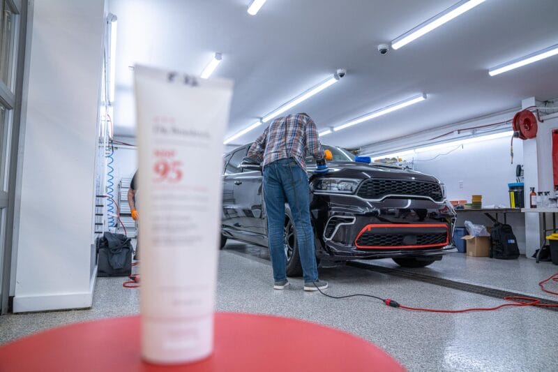 Tube of Dr. Beasley's NSP 95 in the foreground with out of focus Dodge Durango in the background.