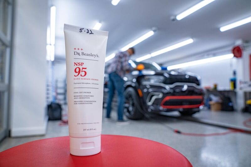 Tube of Dr. Beasley's NSP 95 in the foreground with out of focus Dodge Durango in the background.