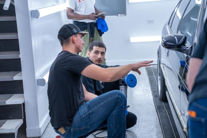 Student receiving instruction before starting a paint correction on E39 M5.