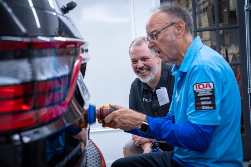 Chris Racana watching on in enjoyment as one of his students gets the hang of Paint Correction.