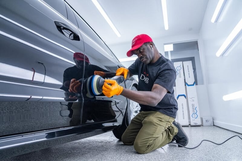 Rupes orbital being used for paint correction on the side of an Audi.