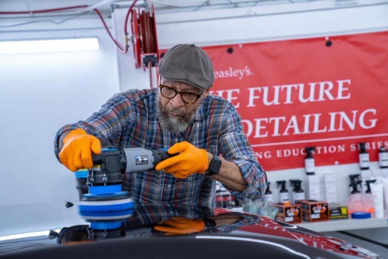Detailer using UDOS Polisher on the roof of a car, performing a paint correction.