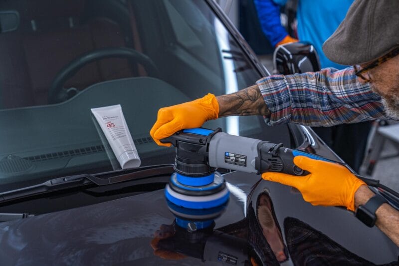 Dodge Durango being paint corrected with a tube of Dr. Beasley's NSP 95 resting on windshield.