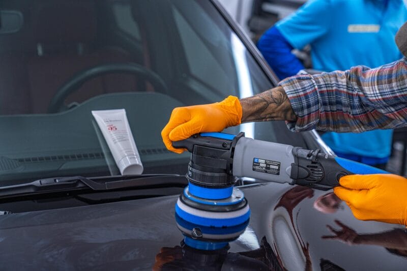 Dodge Durango being paint corrected with a tube of Dr. Beasley's NSP 95 resting on windshield.