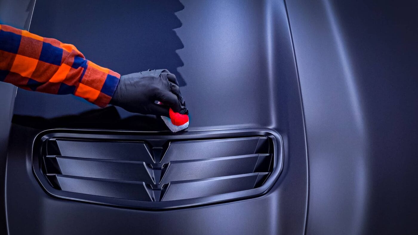 Applying a ceramic coating to the matte vinyl hood of a 2023 Chevrolet Camaro SS 1LE.
