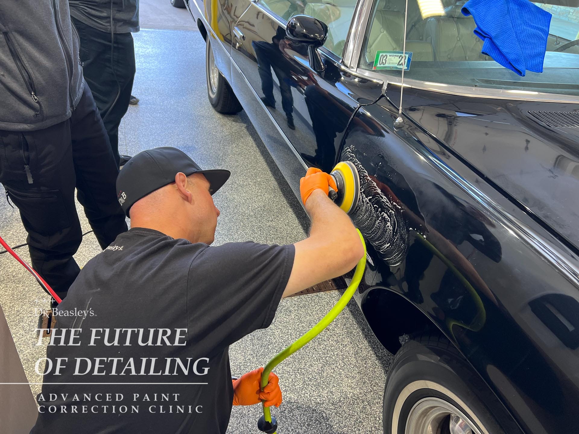 Student wet sanding the fender on a Porsche 911.