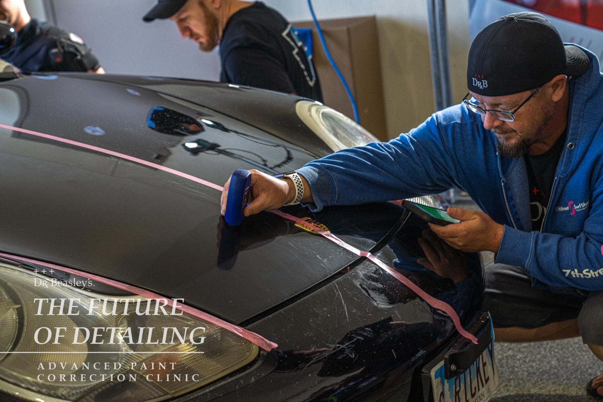 Checking the paint thickness on a Porsche 911 hood.