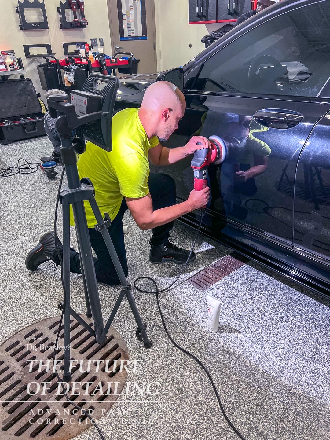 Student polishing the door panel on a BMW.