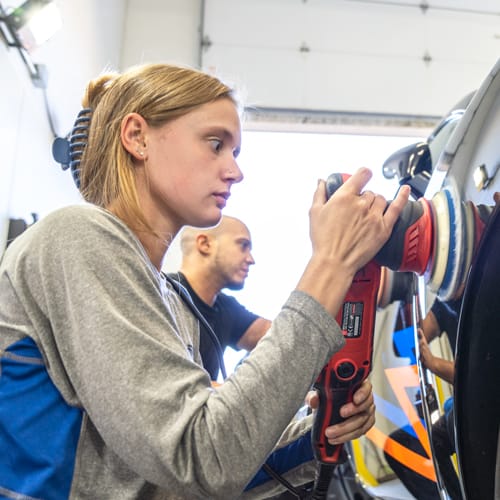 Sierra Lancaster of Era Auto Utah polishing a car.