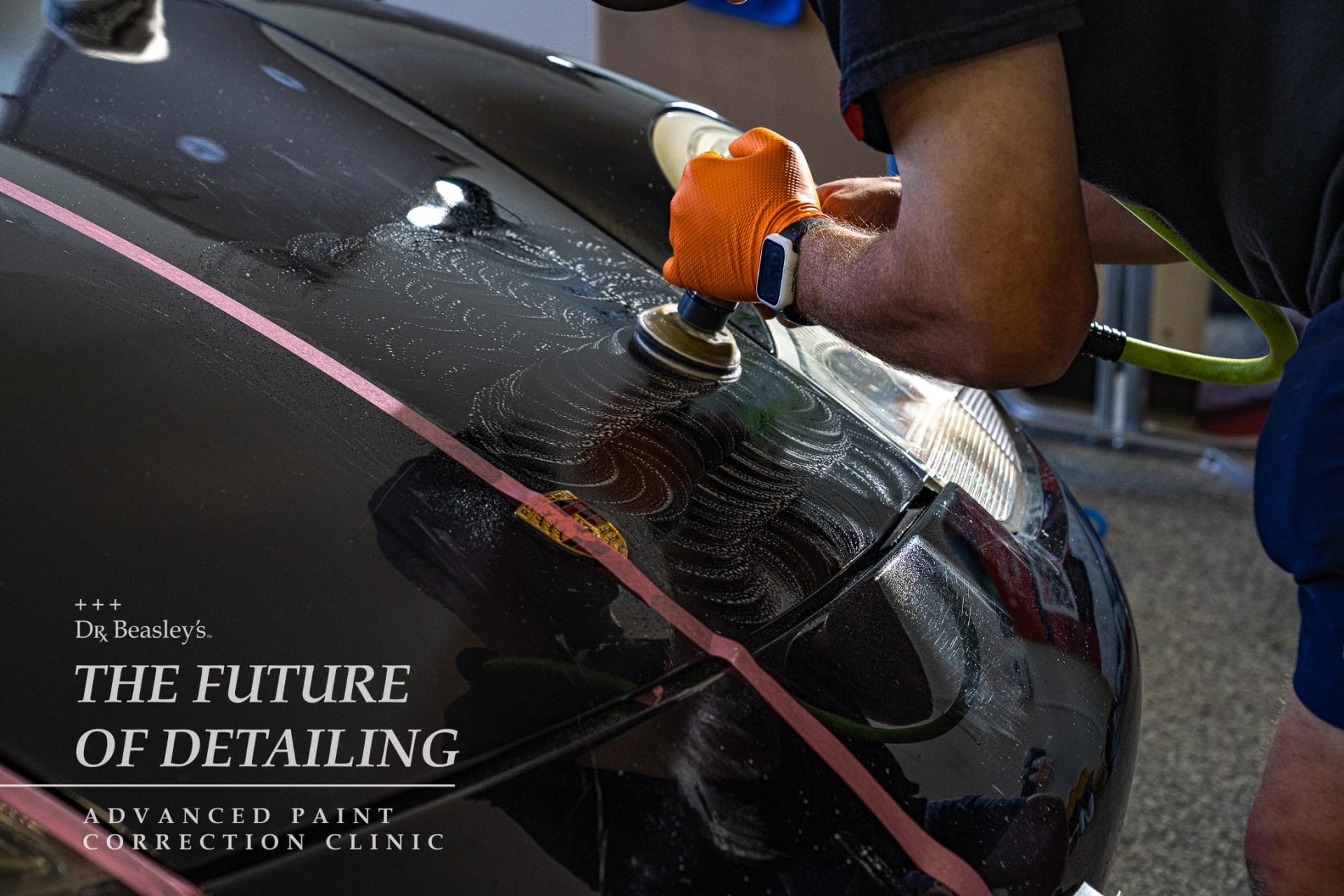 Student wet sanding a Porsche 911 hood.