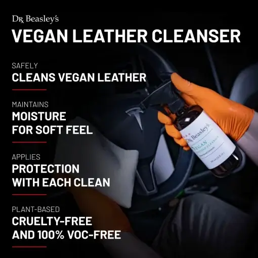 A man wearing orange gloves wipes a black vegan leather Tesla steering wheel with a microfiber towel after spraying Vegan Leather Cleanser.