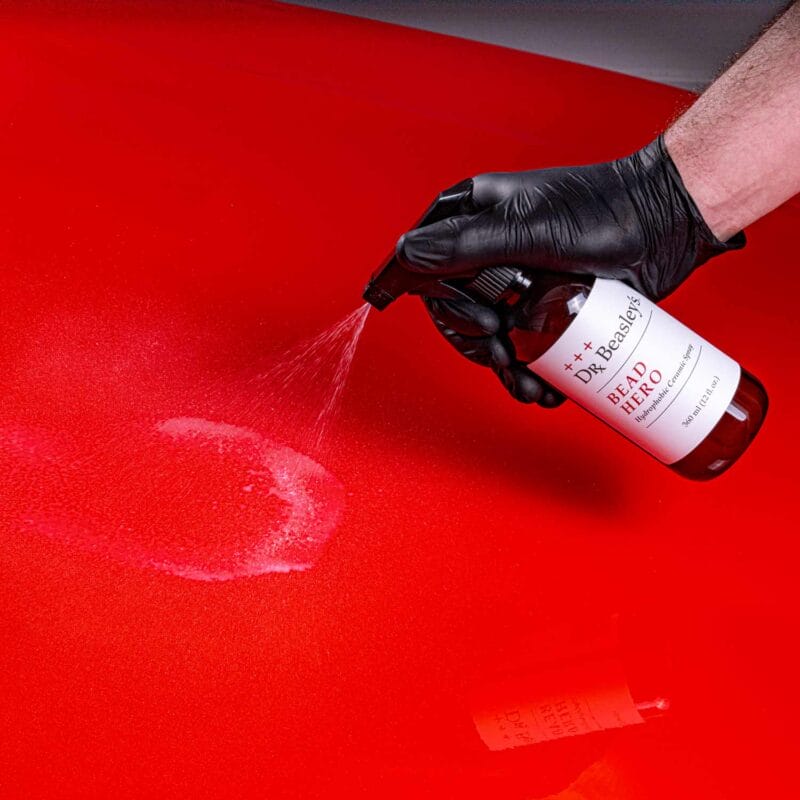 Dr. Beasley's ceramic spray coating Bead Hero spraying onto a red car hood