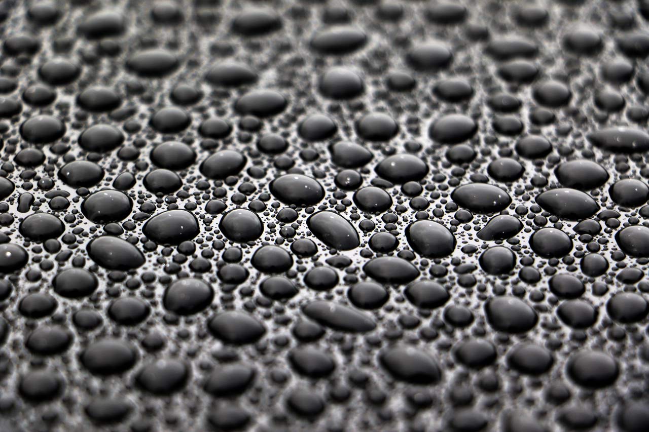 Water beads on a paint surface treated with Bead Hero.