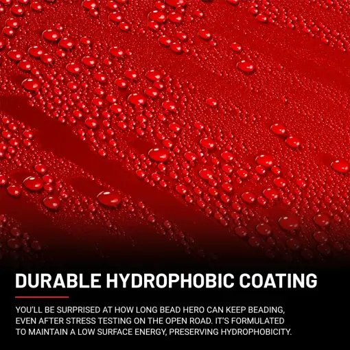 Close-up of a red surface with numerous water droplets beading on it, demonstrating the effectiveness of a hydrophobic coating