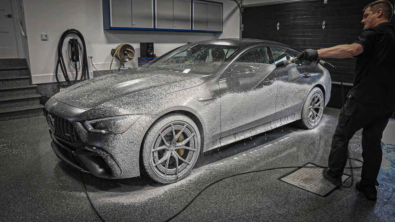 Spraying a matte vehicle with car wash soap foam