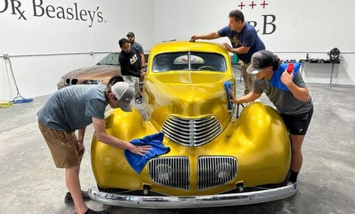 Ceramic coating a vintage car at a Mike Phillips detailing class.