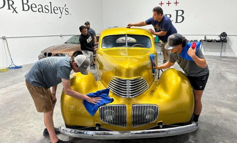 Ceramic coating a vintage car at a Mike Phillips detailing class.