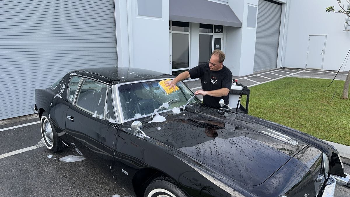 Washing windows on black car