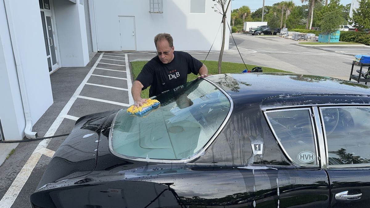 Washing windows on black car