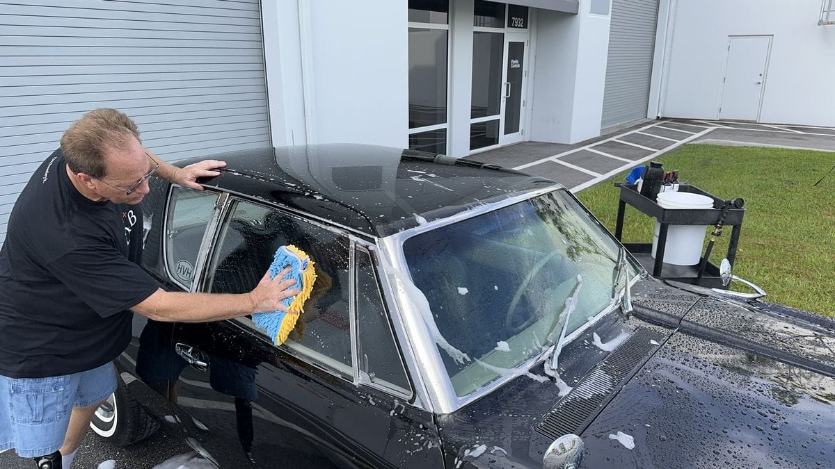Washing windows on black car