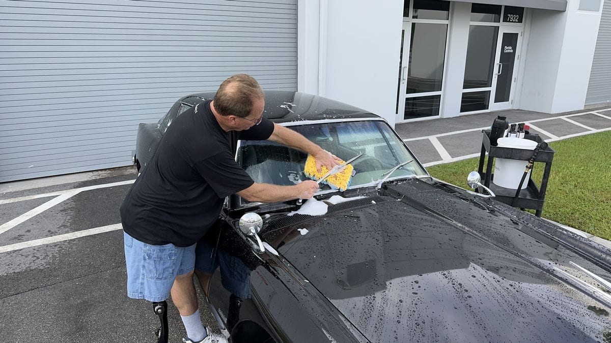 Washing windows on black car