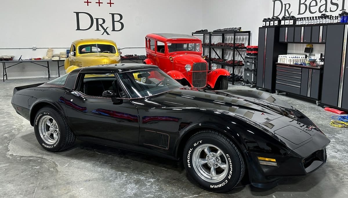 Black corvette in detailing garage