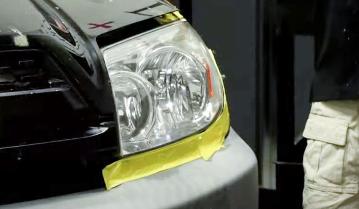 Headlight taped off for sanding restoration