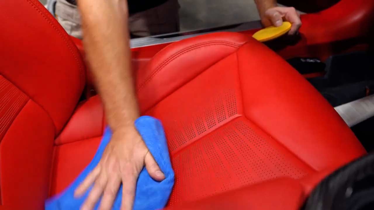 Removing excess leather conditioner residue from red leather seats in Corvette