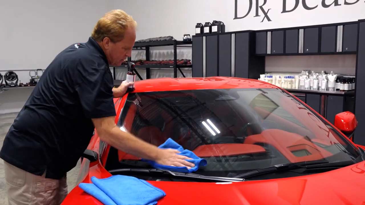 Wiping windshield with a microfiber towel