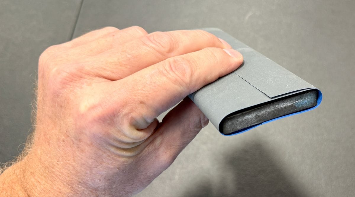 Folding sand paper over sanding block
