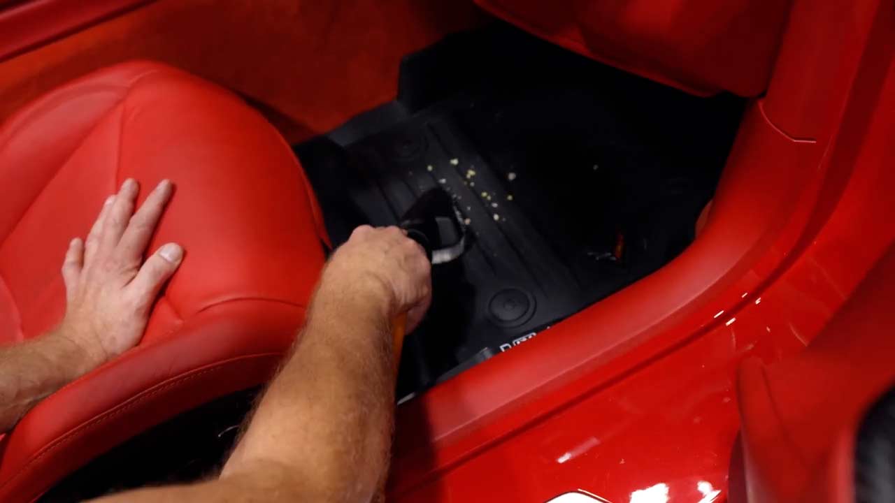 Vacuuming debris in Corvette interior